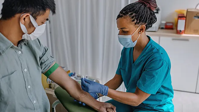 person getting blood drawn by nurse