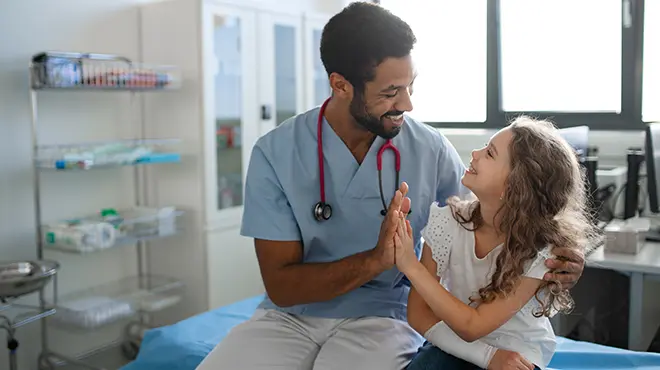 child and doctor high five