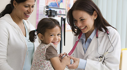 Doctor with Smiling Child and Mother